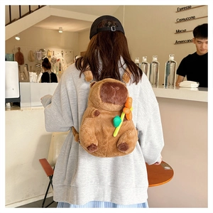 Cute brown capybara plush backpack with flower accessory worn in a cafe setting