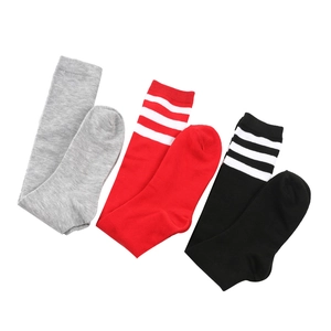 Detail view of striped knee high socks in grey, red, and black JK school style