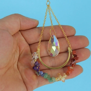 Golden crescent moon suncatcher with chakra crystals and iridescent teardrop pendant
