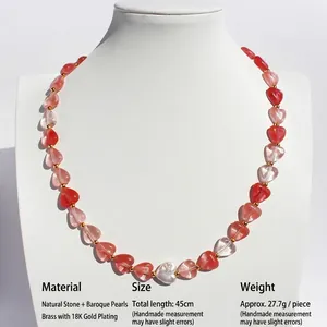 Handmade necklace with natural heart-shaped stones and baroque pearls on a white bust