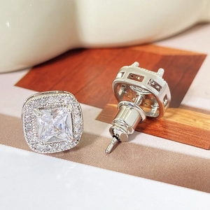 Macro shot of princess cut cubic zirconia halo stud earrings with butterfly backings