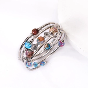 Detail of multi-layered bohemian beaded wrap bracelet with emperor stone and metal spacers