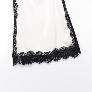 Off-white satin camisole top with black lace trim detailing and smooth silk texture