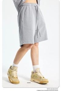 Close-up of grey vintage washed cotton shorts showing texture and drawstring detail