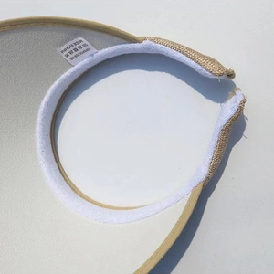 Detail view of woven straw sun hat with 100% polyester label and breathable lining
