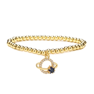 Golden 4mm bead bracelet with planet charm featuring blue star gem and white crystals