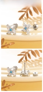 Detail of silver windmill zircon stud earring with blue center stone and screw back cap