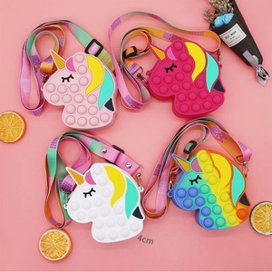Detail showing various colors of unicorn silicone pop-it shoulder bags with adjustable straps