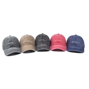 Washed cotton baseball caps with freedom embroidery in five colors on white background