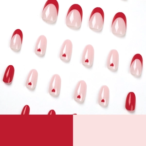 French red heart press-on nails set with oval shape and glossy finish on white backdrop