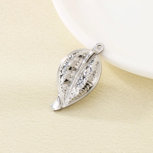 Macro view of 304 stainless steel hollow leaf pendant with textured surface detail