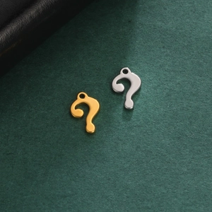 Minimalist gold and silver stainless steel question mark pendants on green background