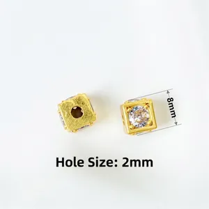 Macro view of 8mm gold square bead with 2mm hole for DIY jewelry making