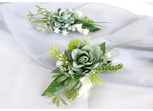 Detailed view of artificial green rose corsage and wrist flower set with leafy accents