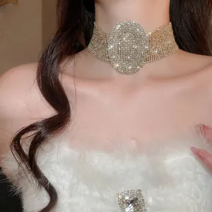 Luxurious gold-tone wide choker necklace with oval rhinestone centerpiece and full crystal wrap