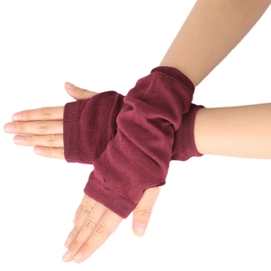 Detailed close-up of dark red ribbed knit fingerless gloves showing fabric texture