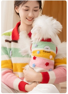 Close-up of colorful striped knit dog sweater with star applique and cloud embroidery