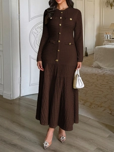 Detailed view of brown knit dress featuring elegant gold buttons and faux pocket accents