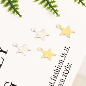 Detailed view of star-shaped metal pendants in gold and silver for DIY jewelry crafting