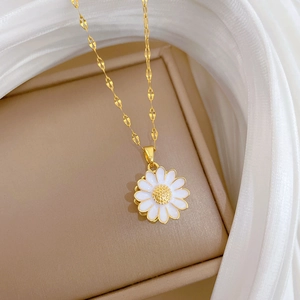 Detail of sunflower pendant necklace with gold finish and crystal on silk ribbon