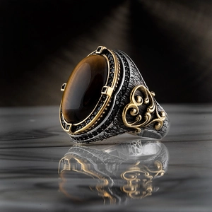 Macro shot of vintage men's ring with tiger eye stone and gold-silver metal finish