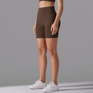 Detail view of high-waisted dark brown yoga shorts with seamless contour and elastic fabric