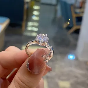 Detailed view of silver six-prong round cut diamond ring with pavé stones on adjustable band