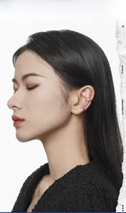 Close-up of wavy gold and silver S925 sterling silver ear cuffs with cubic zirconia