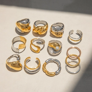 Two-tone 18k gold plated stainless steel rings with zircon stones in modern grid display