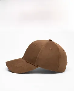 Side view of a brown suede-like baseball cap with six-panel construction and natural curved brim