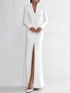 Elegant white long sleeve V-neck dress with decorative buttons and high slit design