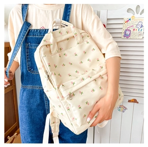 Close-up of floral canvas backpack with pink tulip patterns in a Japanese school style