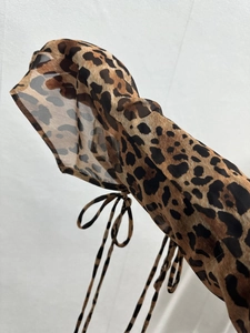 Detail of leopard print chiffon sleeve with adjustable tie strings on the cuff