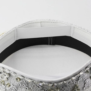 Macro detail of the white captain hat showing inner lining and silver rhinestone trim
