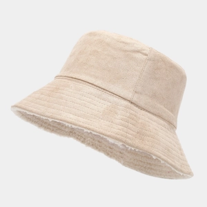 Detail of winter bucket hat showing beige suede exterior and thick white fleece lining