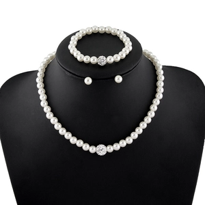Elegant white pearl jewelry set with necklace bracelet and earrings on black mannequin