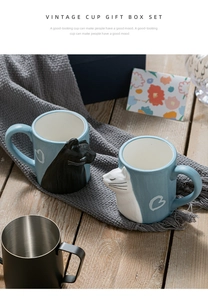 Close-up of vintage ceramic cat mug gift set with 3D embossed hearts on a wooden table