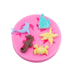 Pink silicone mold featuring sea creatures like seahorses, dolphins and starfish shapes