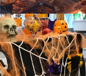Detailed Halloween table setting featuring orange spider webs and spooky skull props