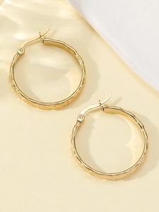 Macro shot of gold quilted hoop earrings in stainless steel with 18k gold plating finish