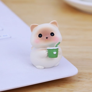 Cute white resin cat figurine holding a green heart cup for car and desk decoration