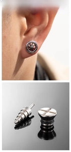 Macro shot of industrial punk style stainless steel cross gear earrings for men and women
