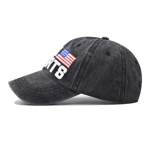 Close-up of side embroidery with USA flag and text on washed cotton baseball cap