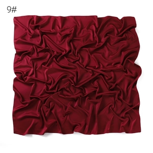 Solid color matte faux silk satin square scarf detail view showing soft fabric texture.