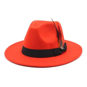 Detailed top view of red cashmere felt hat featuring black ribbon and decorative feathers