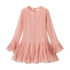 Detail of pink flare dress showing round neck, front buttons, and pleated ruffle hemline