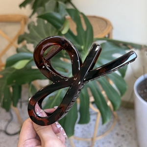 Detail showing the large tortoiseshell hair claw clip in elegant amber resin finish