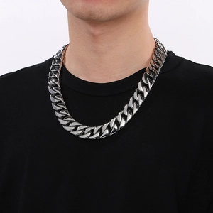 Close-up of 20mm polished silver Cuban link chain necklace on model neck