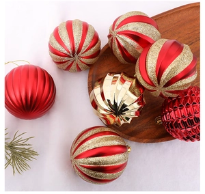 Detailed view of red and gold shatterproof Christmas ornaments with diverse textures