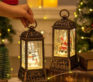 Close-up of vintage bronze Christmas lanterns with Santa and snowman inside, warm LED glow